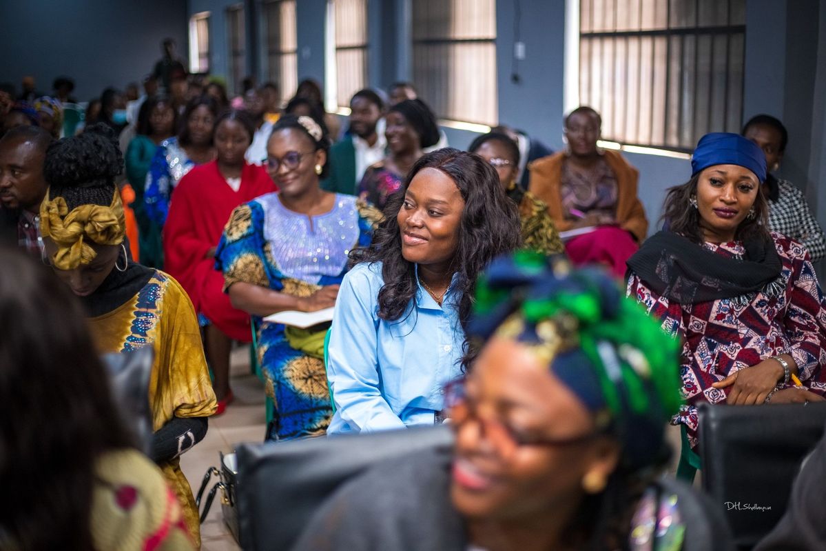 Empowered African woman in a supportive community setting